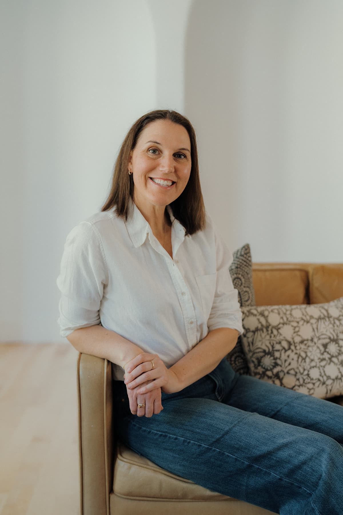 Hailey Powell seated in a warm, inviting home interior